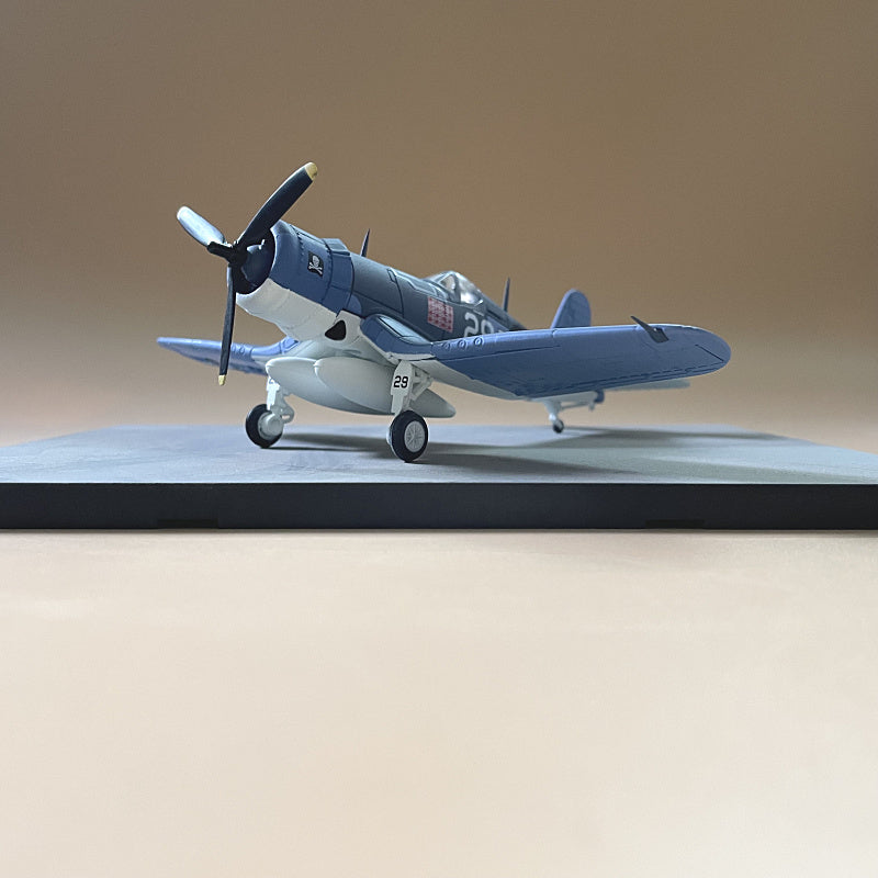 Scale model of a blue F4U Corsair WWII fighter plane on a display base