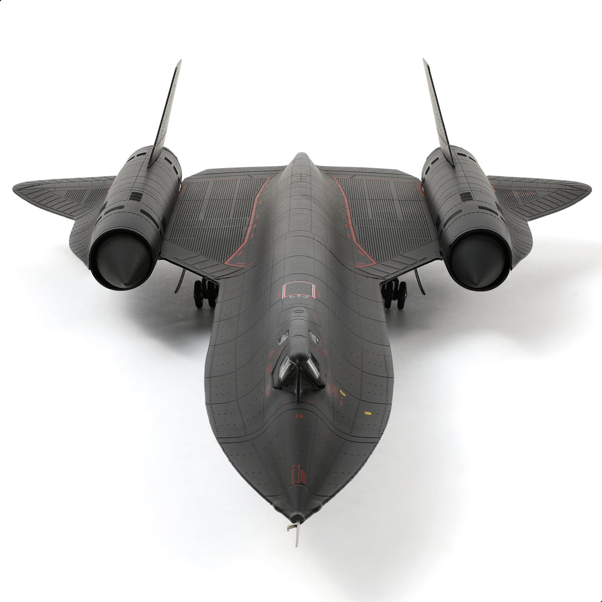 Top view of a detailed SR-71 Blackbird scale model aircraft on a white background