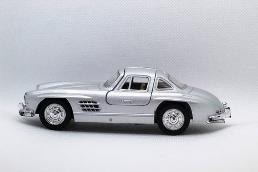 a silver model car on a white background
