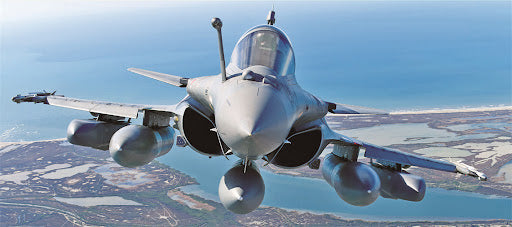 Dassault Rafale multi-role fighter jet flying over a coastal landscape