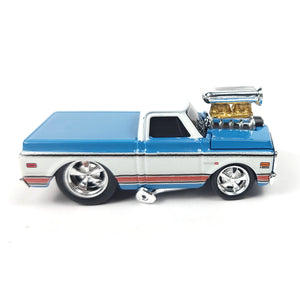 Side view of the die-cast 1972 Chevrolet C10 pickup truck model in blue and white with chrome wheels.