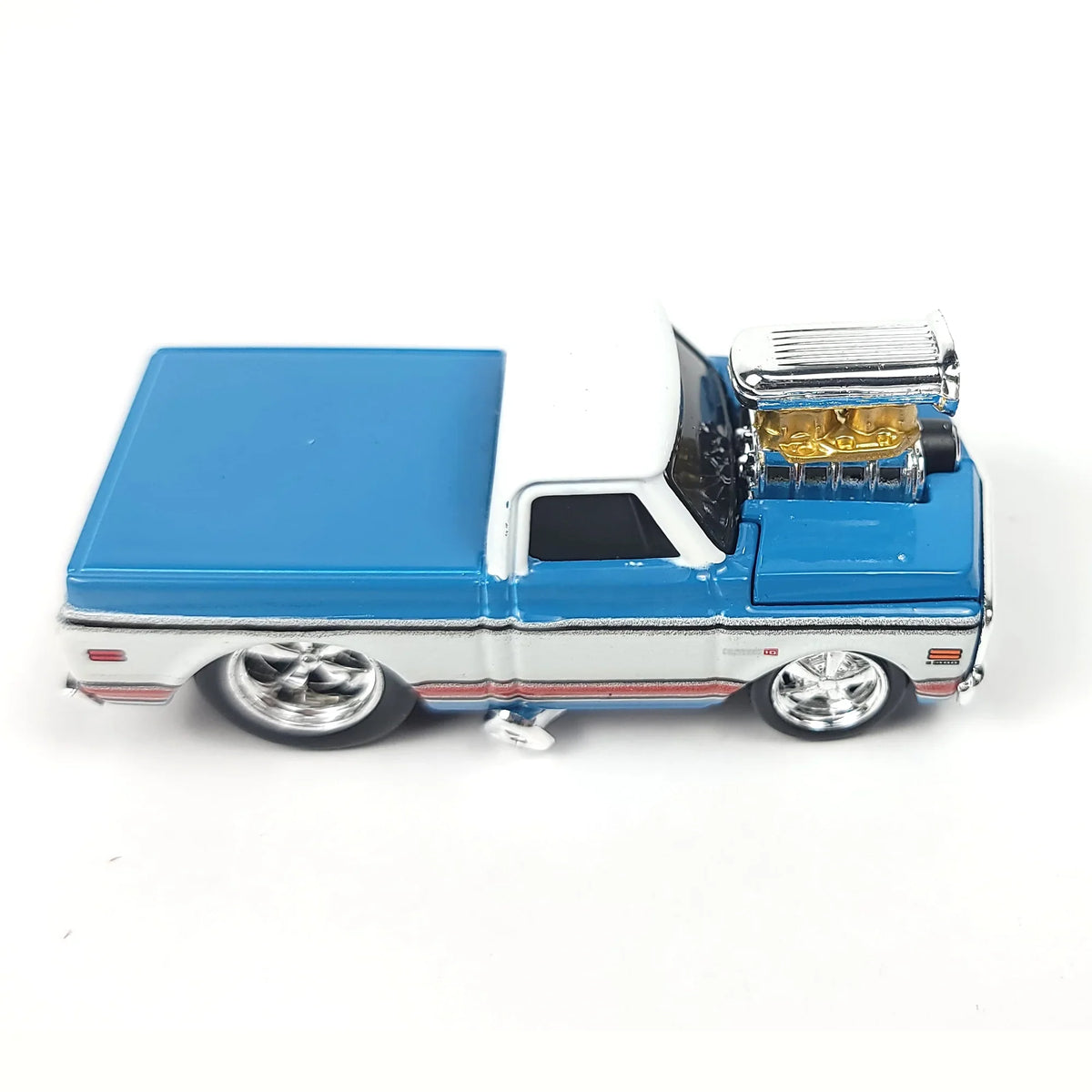 Die-cast 1972 Chevrolet C10 pickup truck model in blue and white with chrome details and a visible engine.