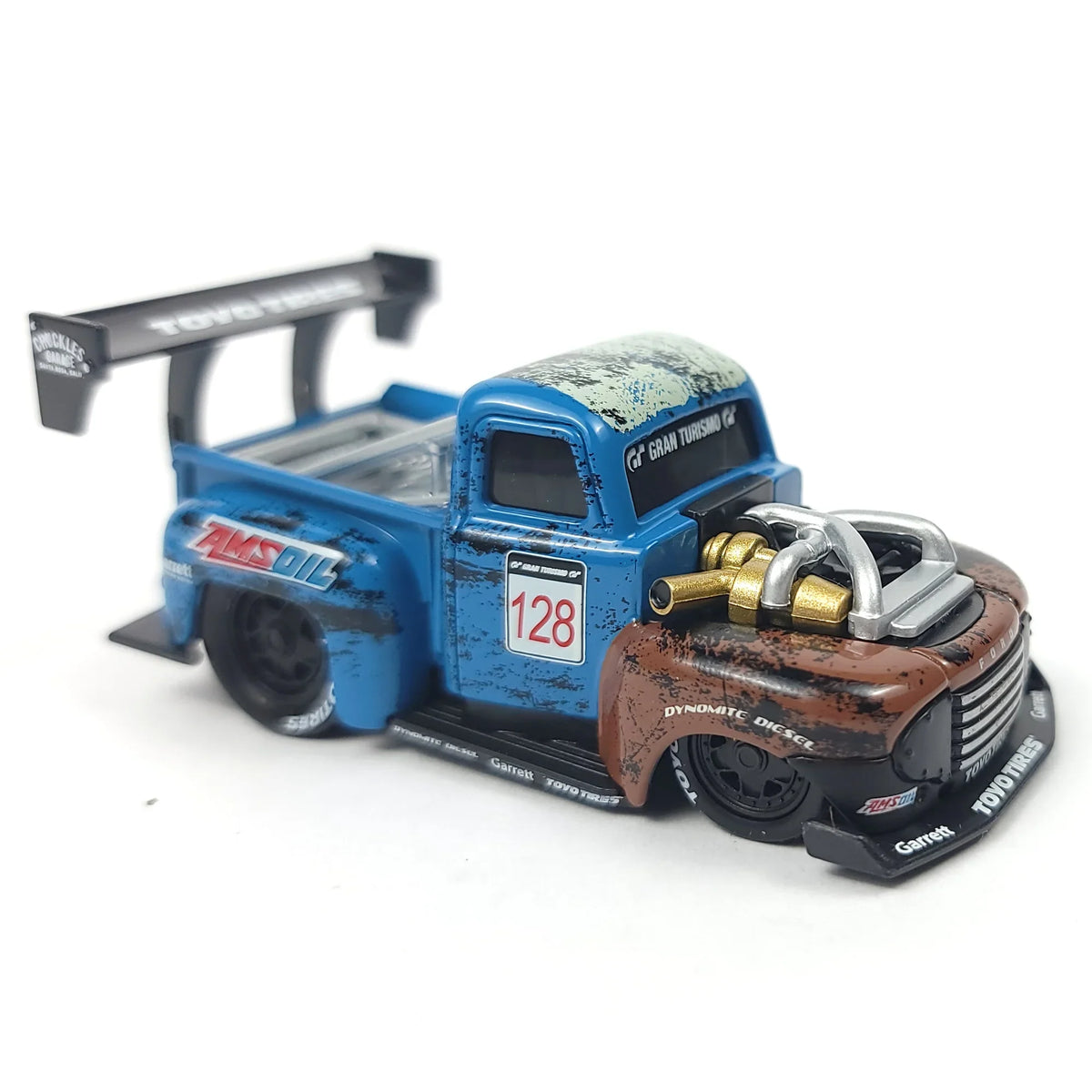 Die-cast 1949 Ford F1 Pickup Truck model in blue and brown with racing details and a large rear wing.