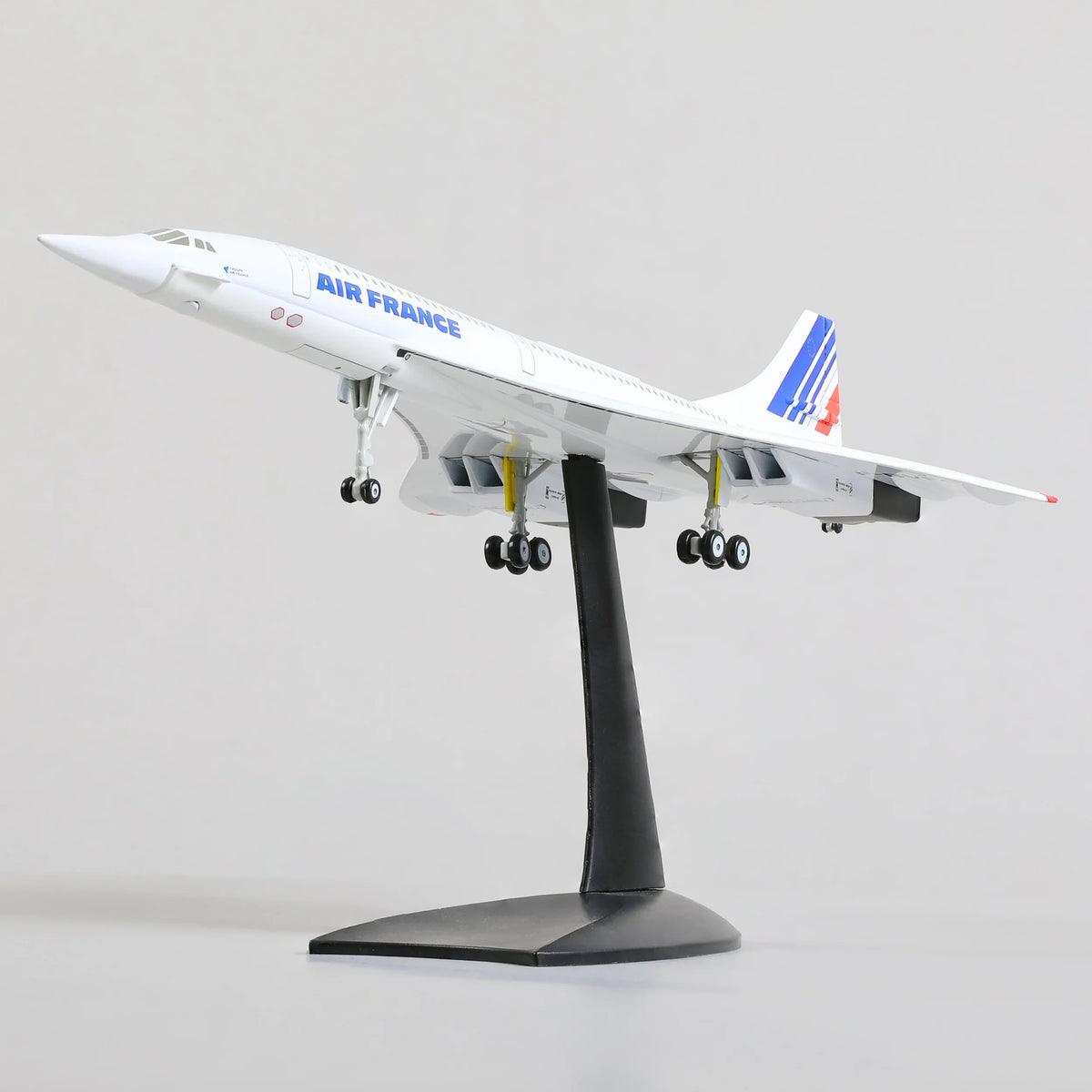 QIYUMOKE Concorde Air France diecast airplane model from a front angle on a stand