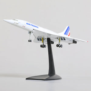QIYUMOKE Concorde Air France diecast airplane model from a front angle on a stand