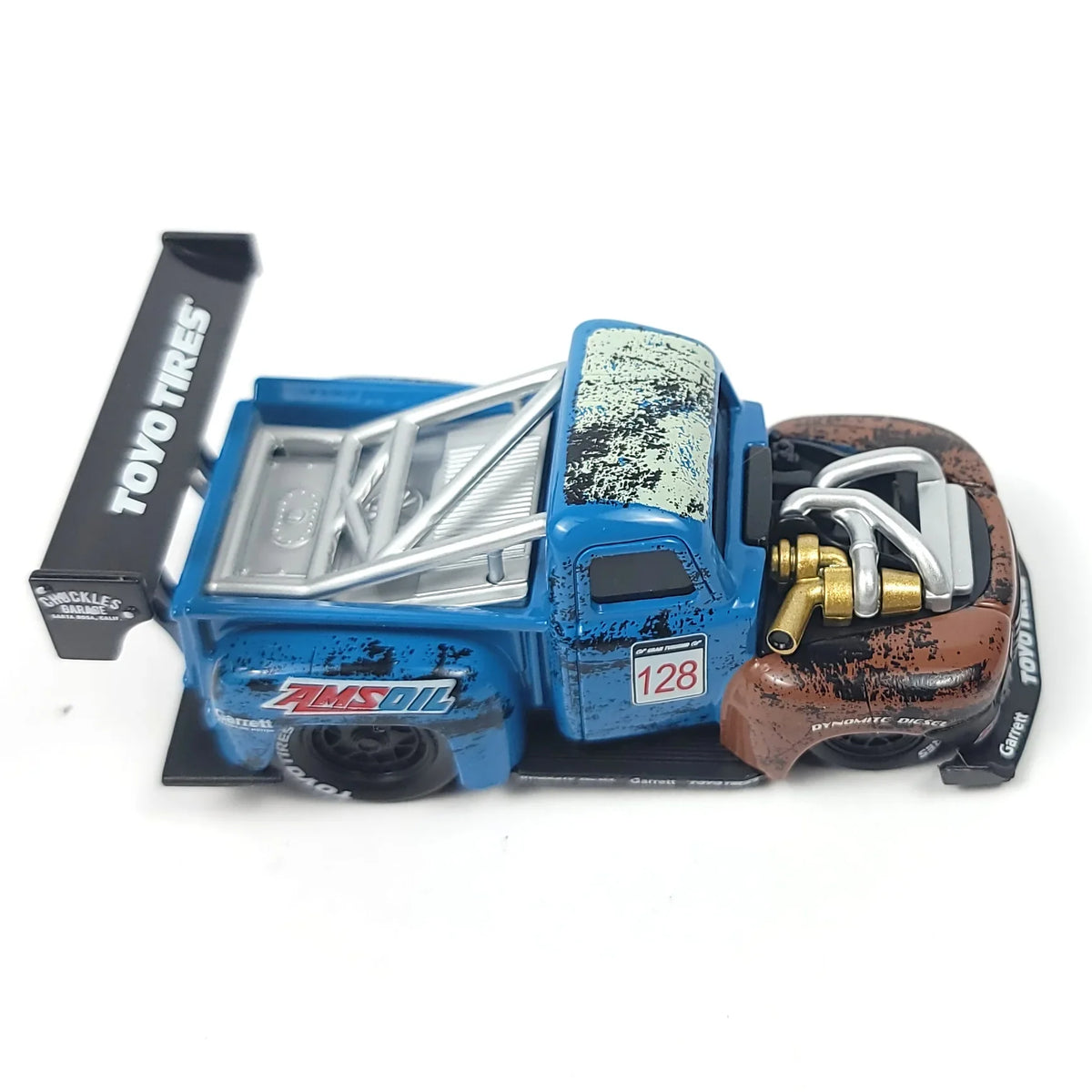 Die-cast 1949 Ford F1 Pickup Truck model in blue and brown with a rear wing and detailed engine components.