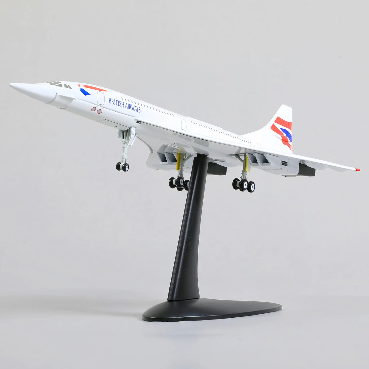 QIYUMOKE 1:200 Aerospatiale/BAC Concorde diecast model aircraft in British Airways livery, side profile view on a stand.