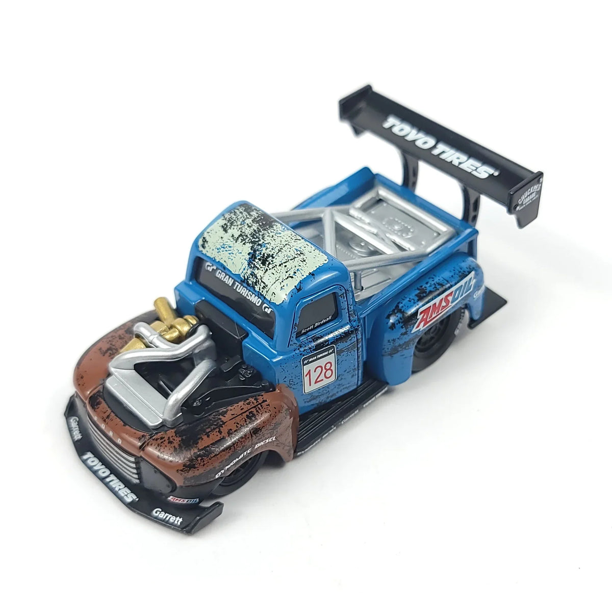 Side angle of the 1949 Ford F1 Pickup Truck model featuring the blue body, rear wing, and racing details.