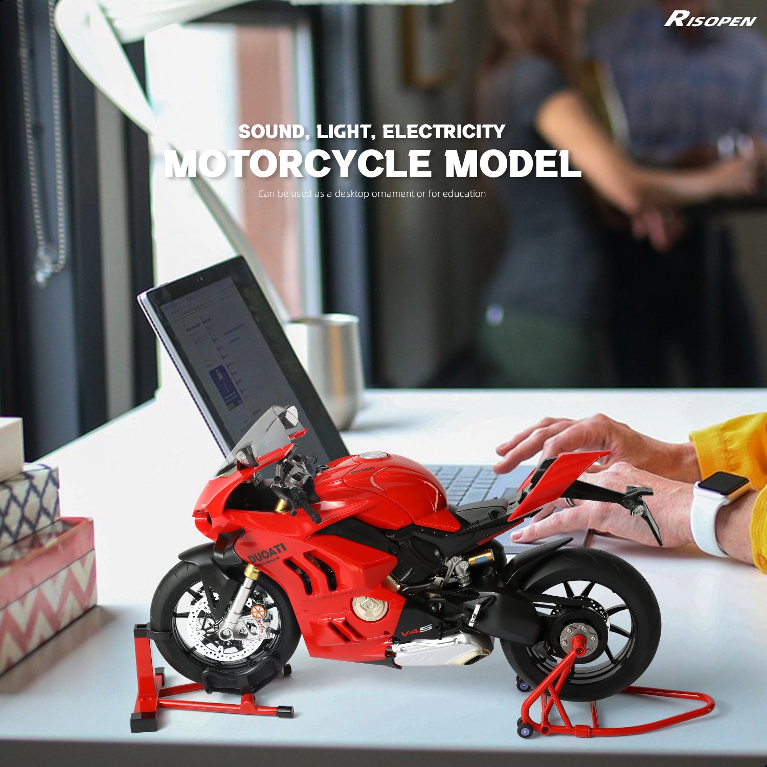 Ducati motorcycle model in red on a desk next to a laptop, highlighting its use as a decorative piece.