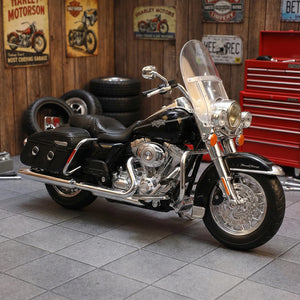 Maisto 2013 Flhrc Road King Classic motorcycle toy in black, front view in garage setting