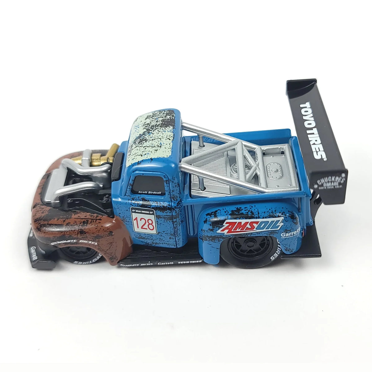 Die-cast 1949 Ford F1 pickup truck model in blue with a brown front fender and racing details.