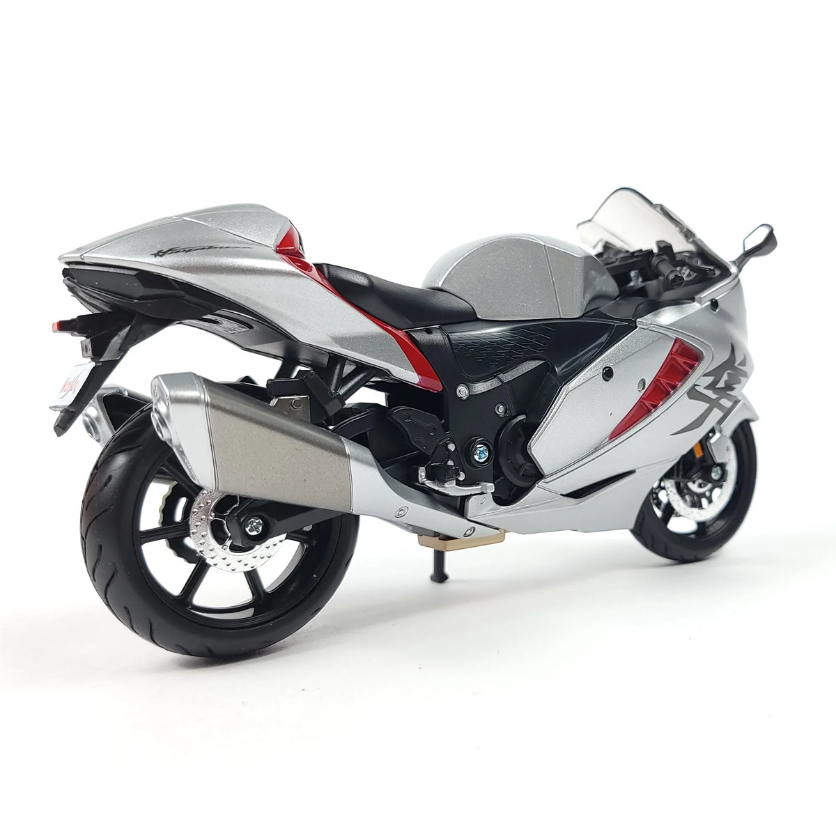 Die-cast Suzuki Hayabusa GSX1300R motorcycle model in silver and black, showcasing rear view with detailed design.