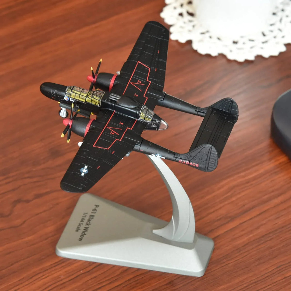 NUOTIE Model 1/144 Scale Northrop P-61B Black Widow aircraft in black, viewed from above on a stand.