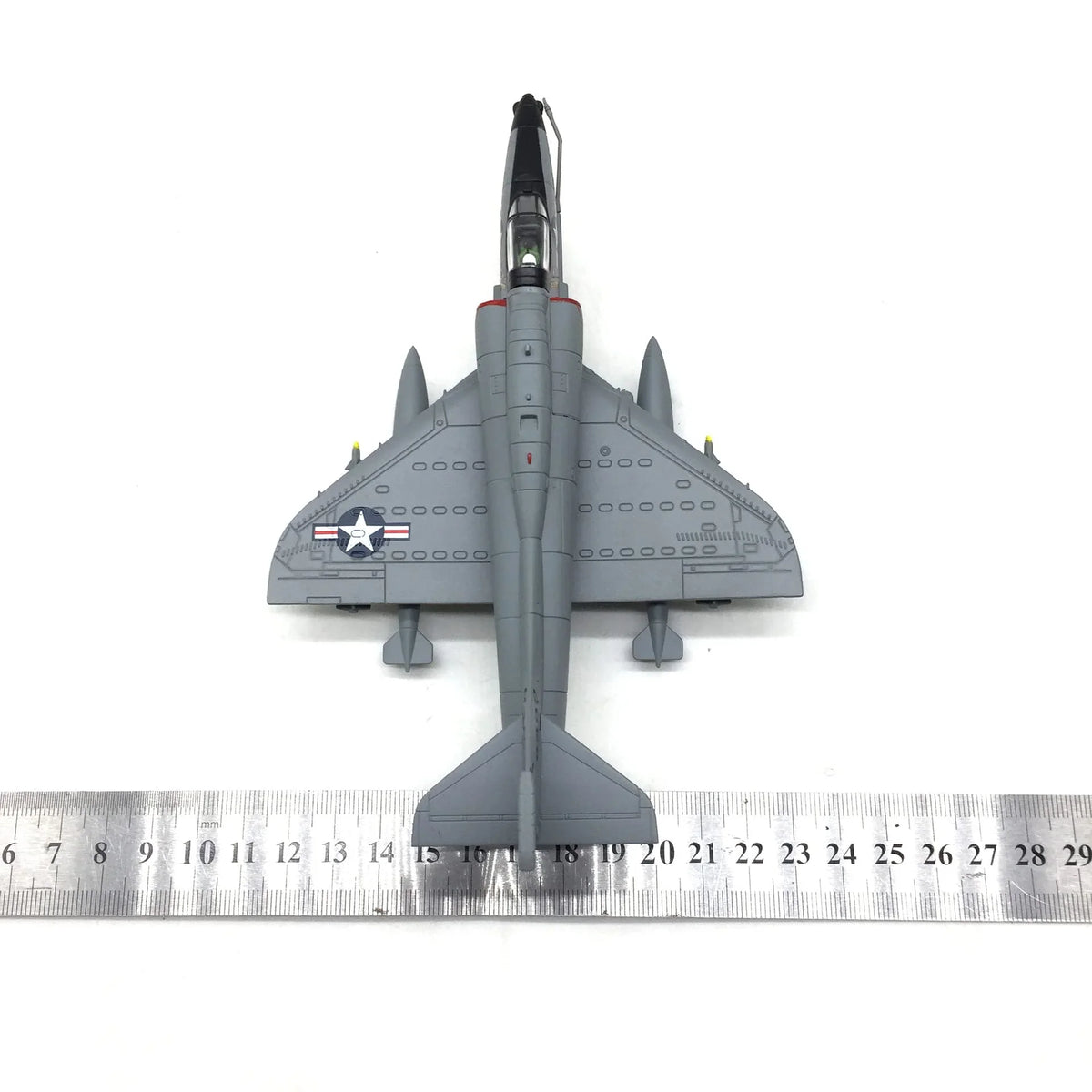 NUOTIE A-4 Skyhawk diecast model in gray, top view with ruler for scale
