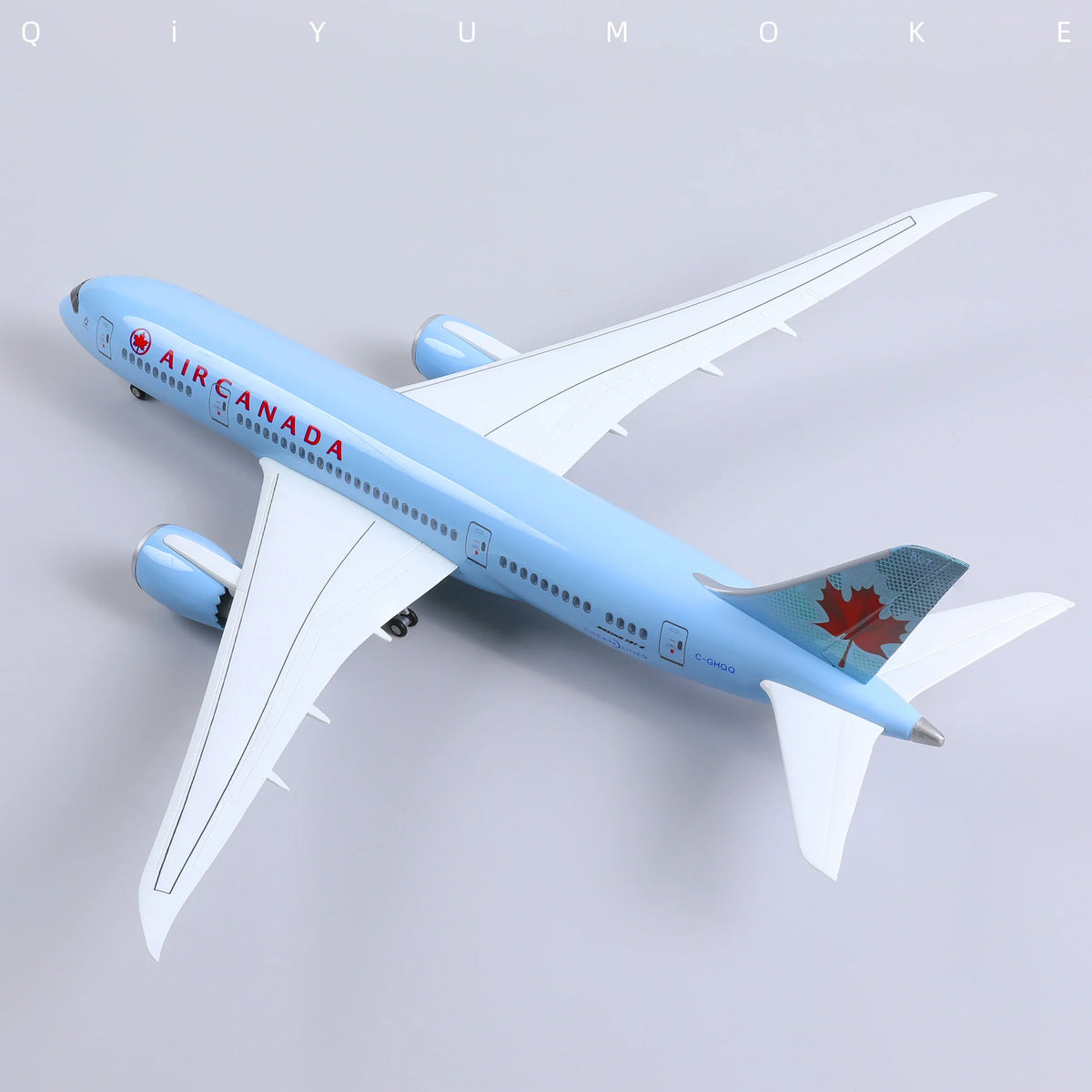QIYUMOKE 1/130 Boeing 787-8 Air Canada diecast airplane model in blue with a maple leaf design, top view