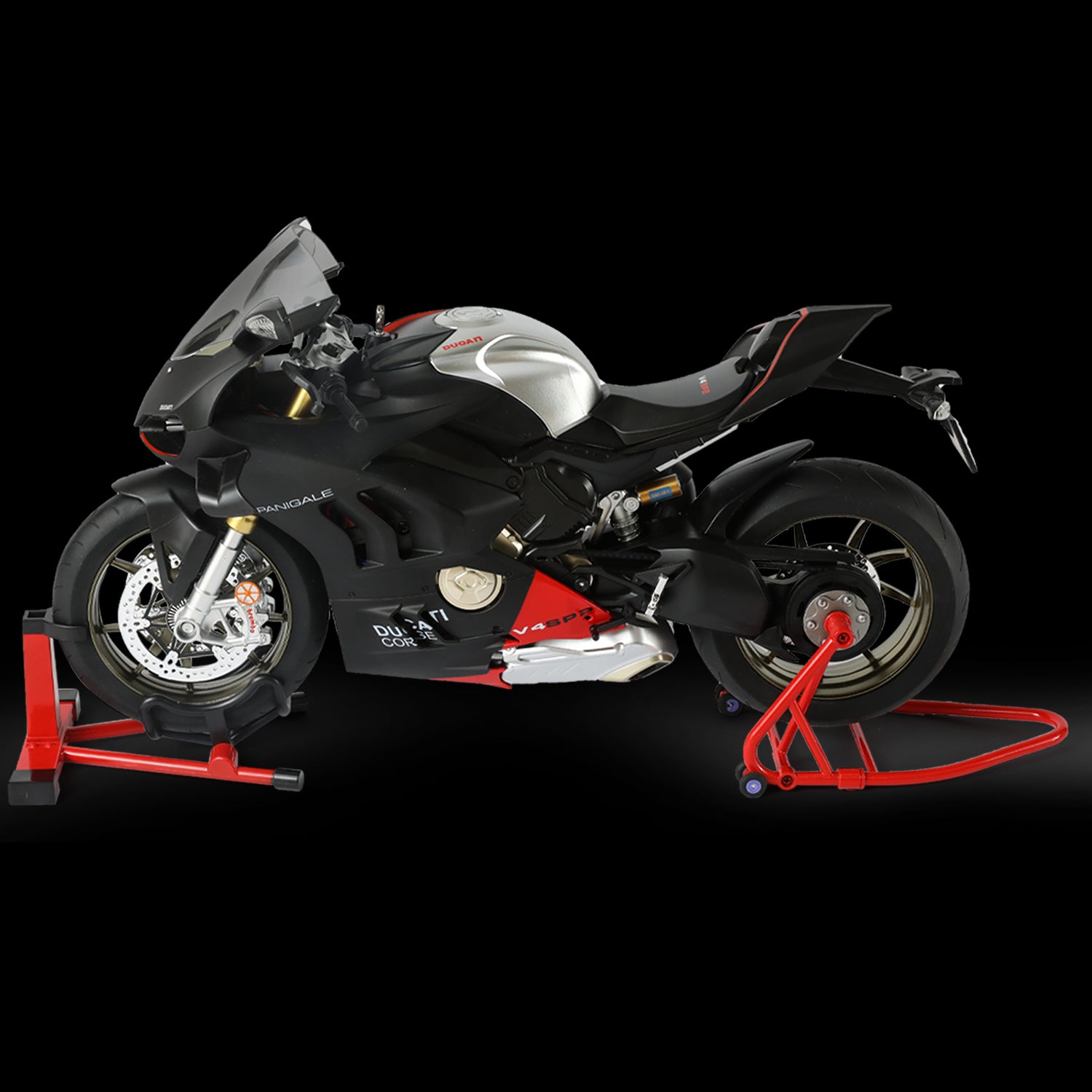 Side view of Ducati Panigale V4 SP2 motorcycle model in black and silver, displayed on a stand against a black background.