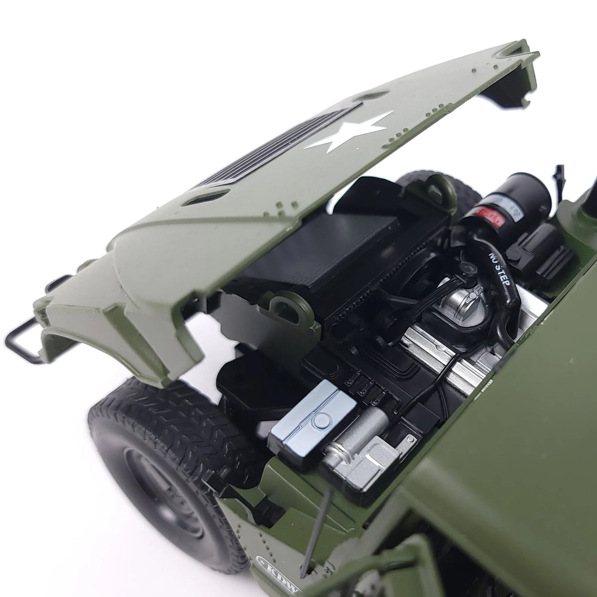 Close-up of the Hummer H1 model's engine compartment with the hood raised, revealing engine details.