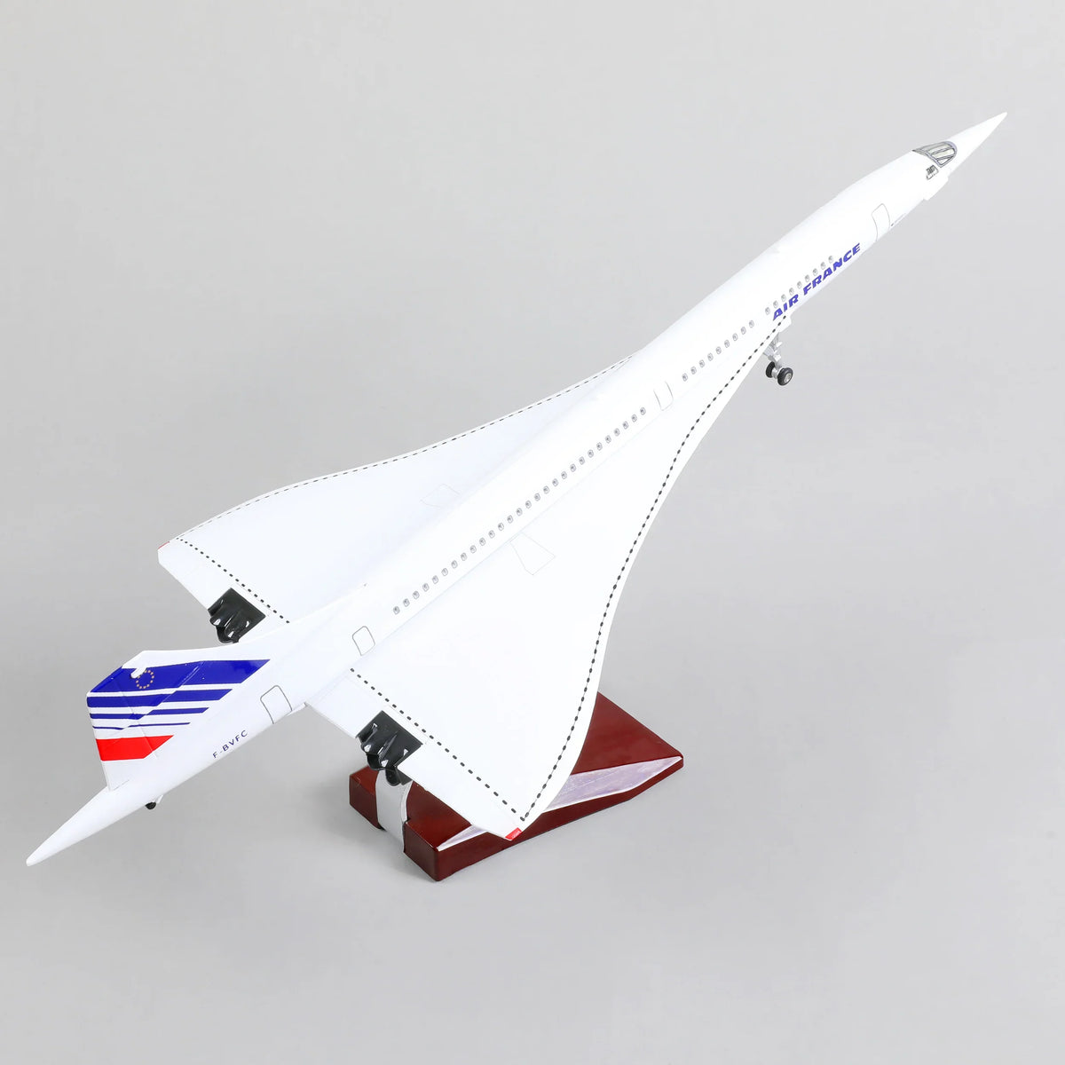 QIYUMOKE Concorde Air France diecast airplane model in white, angled upward on a wooden display stand