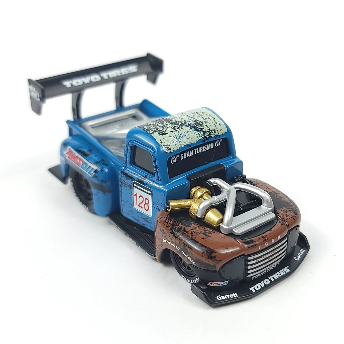 Die-cast 1949 Ford F1 pickup truck model in blue and brown with racing details and a rear spoiler.