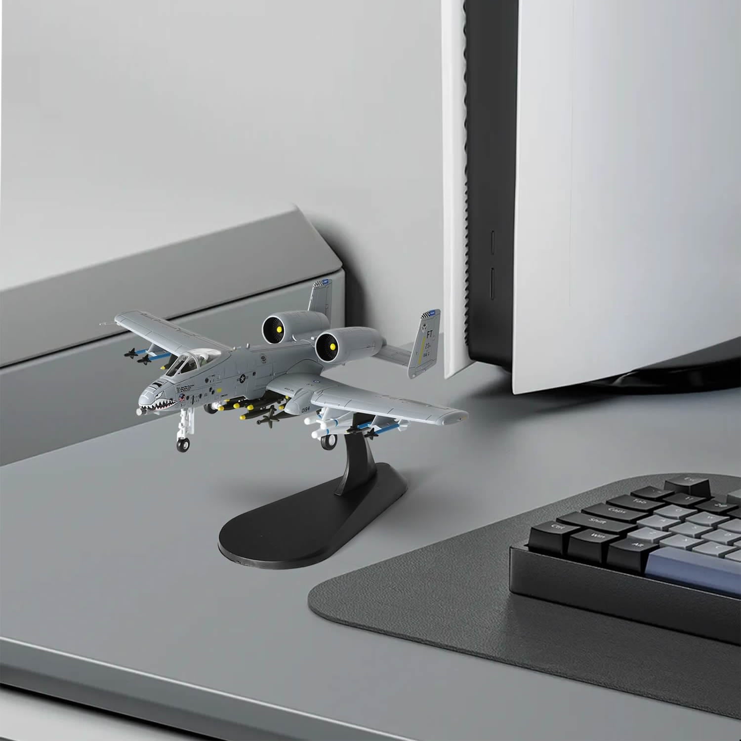 NUOTIE Model A-10 Thunderbolt II diecast aircraft on a desk next to a computer