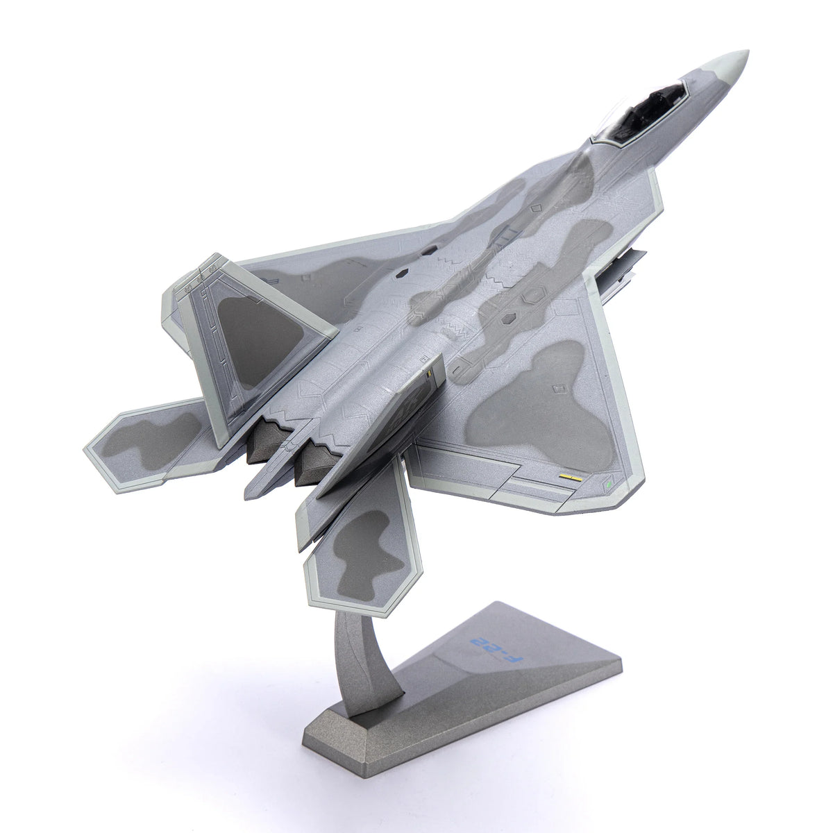 NUOTIE F-22 Raptor diecast metal model in gray camouflage, angled view on display stand